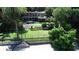 Expansive backyard featuring lush landscaping, a sparkling pool, and multi-story home at 1105 Lake Nettie Dr, Eustis, FL 32726