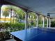 Covered game room with ping pong table overlooking waterfall feature and lake views at 1105 Lake Nettie Dr, Eustis, FL 32726