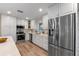 Modern kitchen with stainless steel appliances, white cabinets, and solid surface countertops at 1105 Lake Nettie Dr, Eustis, FL 32726