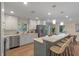 Bright kitchen featuring stainless steel appliances, white cabinetry, and breakfast bar at 1105 Lake Nettie Dr, Eustis, FL 32726