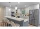Beautiful kitchen featuring stainless steel appliances, stylish pendant lighting, and eat in breakfast bar at 1105 Lake Nettie Dr, Eustis, FL 32726