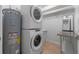 Laundry room features a stacked washer/dryer and water heater at 1105 Lake Nettie Dr, Eustis, FL 32726