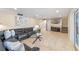 Relaxing living room with tile flooring, recessed lighting, and comfortable leather sofas at 1105 Lake Nettie Dr, Eustis, FL 32726