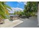 Lakeside patio featuring a hot tub with tropical landscaping and a view of the water at 1105 Lake Nettie Dr, Eustis, FL 32726