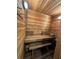 Inviting sauna features all-wood construction, a built-in bench, and essential accessories for a rejuvenating experience at 1105 Lake Nettie Dr, Eustis, FL 32726
