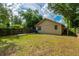 Fenced backyard with green grass, wood pathway and trees at 111 E Caroline St, Tavares, FL 32778