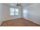 Bedroom with a ceiling fan and window providing natural light at 111 E Caroline St, Tavares, FL 32778