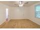 Bright bedroom featuring a ceiling fan and a window for natural light at 111 E Caroline St, Tavares, FL 32778