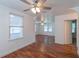 Bright and airy living room with hardwood floors, large windows, and arched doorways at 111 E Caroline St, Tavares, FL 32778