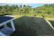 Expansive backyard with lush green grass, mature trees, and a modern black fence at 1157 Basalt Ln, Sanford, FL 32771