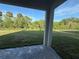 View from the covered patio onto a grass backyard with a dark fence bordering the perimeter at 1157 Basalt Ln, Sanford, FL 32771