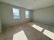 A spacious bedroom awaits personalization with abundant natural light streaming through two windows and neutral walls at 1157 Basalt Ln, Sanford, FL 32771