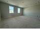 Large bedroom featuring two windows and gray walls at 1157 Basalt Ln, Sanford, FL 32771