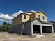 Side view of the new two-story home showing the foundation and structure at 1157 Basalt Ln, Sanford, FL 32771
