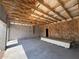 Interior of a two-car garage featuring a concrete foundation and partially-finished walls at 1157 Basalt Ln, Sanford, FL 32771