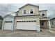 Two-story home featuring a three car garage and stone driveway at 1157 Basalt Ln, Sanford, FL 32771