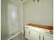 Bathroom featuring white tile shower, white vanity, gray walls and tile flooring at 1161 Basalt Ln, Sanford, FL 32771