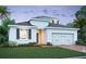 Beautiful exterior showcasing a two-story home with manicured landscaping and a two-car garage with lush green grass at 1161 Basalt Ln, Sanford, FL 32771