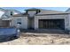 Under construction exterior with gray concrete walls, a garage door opening, and window on a sunny day at 1161 Basalt Ln, Sanford, FL 32771