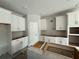 Bright kitchen featuring white cabinets, gray walls, and a center island awaiting finishing touches at 1161 Basalt Ln, Sanford, FL 32771