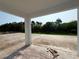Covered patio with brick flooring and a view of the backyard featuring a black fence and mature trees at 1161 Basalt Ln, Sanford, FL 32771