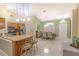 Bright open floor plan with kitchen island and tile floors, combining dining and living spaces seamlessly at 1161 Hackberry Dr, Orlando, FL 32825