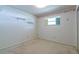 A bedroom showcasing a minimalist design with shelves and one window bringing in natural light at 1221 Adams St, Longwood, FL 32750