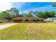 Charming single-story home with a well-maintained lawn and stone accents, providing an inviting curb appeal at 1221 Adams St, Longwood, FL 32750