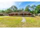 Charming single-story home with a well-maintained lawn and stone accents, providing an inviting curb appeal at 1221 Adams St, Longwood, FL 32750