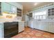 Charming kitchen with white cabinets, a vintage stove, and colorful floral accents at 1221 Adams St, Longwood, FL 32750