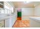 A brightly lit kitchen with a white countertops and a glimpse into the adjacent room at 1221 Adams St, Longwood, FL 32750