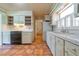 Vintage-style kitchen with white cabinets, tile countertops, and a view into the hallway at 1221 Adams St, Longwood, FL 32750