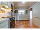 Traditional kitchen with white cabinetry, stainless steel appliances, and tile flooring at 1221 Adams St, Longwood, FL 32750