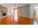 Living room featuring wood floors, stone fireplace, and sliding glass doors at 1221 Adams St, Longwood, FL 32750