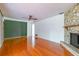 Spacious living room with wood floors, stone fireplace, and ceiling fan at 1221 Adams St, Longwood, FL 32750