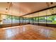 Spacious enclosed patio with tile flooring, offering a serene view of the private backyard at 1221 Adams St, Longwood, FL 32750