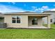 The backyard features a covered patio, green grass, and easy access to the interior at 1221 August Sky Dr, Deltona, FL 32738