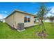 This backyard features a grassy lawn, trees, and a covered patio for outdoor enjoyment at 1221 August Sky Dr, Deltona, FL 32738