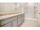 This spacious bathroom offers double sinks, a walk-in shower, and tile flooring at 1221 August Sky Dr, Deltona, FL 32738