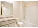 Bright bathroom with white vanity, mirror, toilet, and shower-tub combination at 1221 August Sky Dr, Deltona, FL 32738