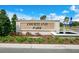 Close-up view of Courtland Park sign with colorful landscaping, fountain, and community flag at 1221 August Sky Dr, Deltona, FL 32738