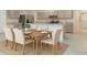 Open concept kitchen with gray cabinetry, stainless appliances, island, dining table, and modern chairs at 1221 August Sky Dr, Deltona, FL 32738
