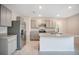 Well-lit kitchen featuring gray cabinets, stainless steel appliances, and tiled floors at 1221 August Sky Dr, Deltona, FL 32738
