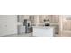 Modern kitchen with gray cabinets, stainless steel appliances, and center island at 1221 August Sky Dr, Deltona, FL 32738