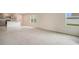 Spacious living room featuring neutral-toned carpet, natural light, and an open layout at 1221 August Sky Dr, Deltona, FL 32738