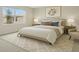 Cozy main bedroom with large window, neutral walls, patterned pillows, bedside tables, and carpet at 1221 August Sky Dr, Deltona, FL 32738
