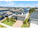 Aerial view of a beautifully landscaped two-story home with solar panels in a residential neighborhood at 13320 Magnolia Valley Dr, Clermont, FL 34711