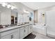 The primary bathroom showcases double sinks with gray countertops, and a separate shower and soaking tub at 13320 Magnolia Valley Dr, Clermont, FL 34711