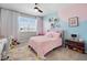 Charming pink bedroom with a fluffy rug, bright windows, and colorful decorations for a playful and inviting space at 13320 Magnolia Valley Dr, Clermont, FL 34711