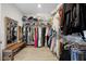Walk-in closet with shelving, a mirror, and a wooden bench for convenient dressing at 13320 Magnolia Valley Dr, Clermont, FL 34711